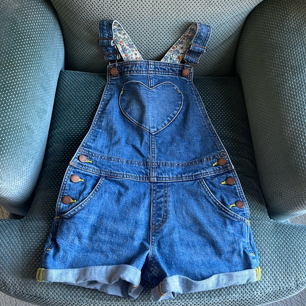 Mini Boden denim overall shorts.